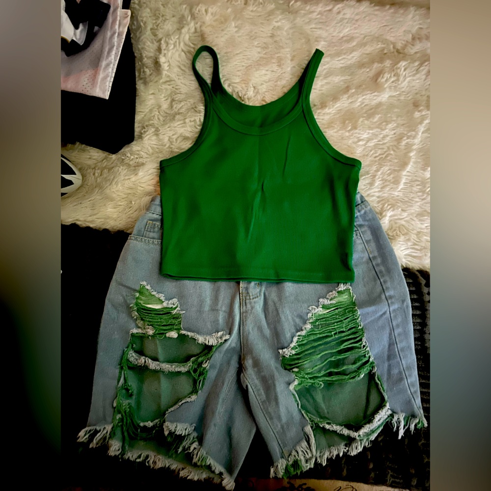 Distressed jean shorts with green in the pattern